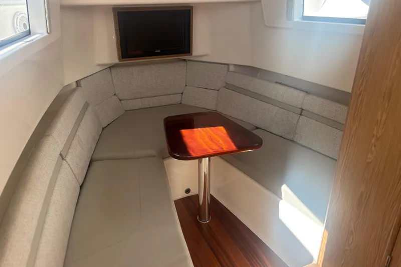Slide: The Image of 2021 Pursuit S 378 Sport cabin interior with seating and table. - 16