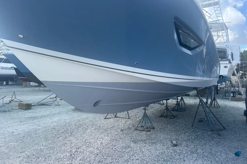 Slide: The Image of 2021 Pursuit S 378 Sport boat on stands in a gravel yard. - 20