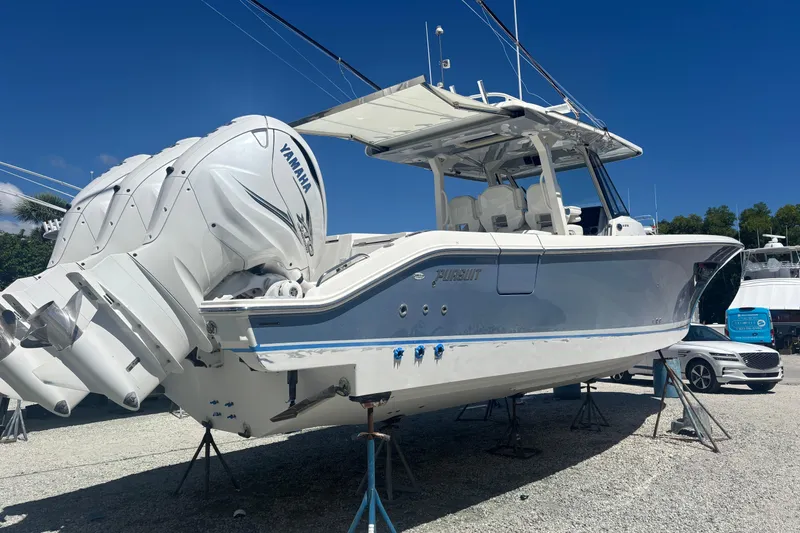 Slide: The Image of 2021 Pursuit S 378 Sport boat with Yamaha engines on display outdoors. - 21