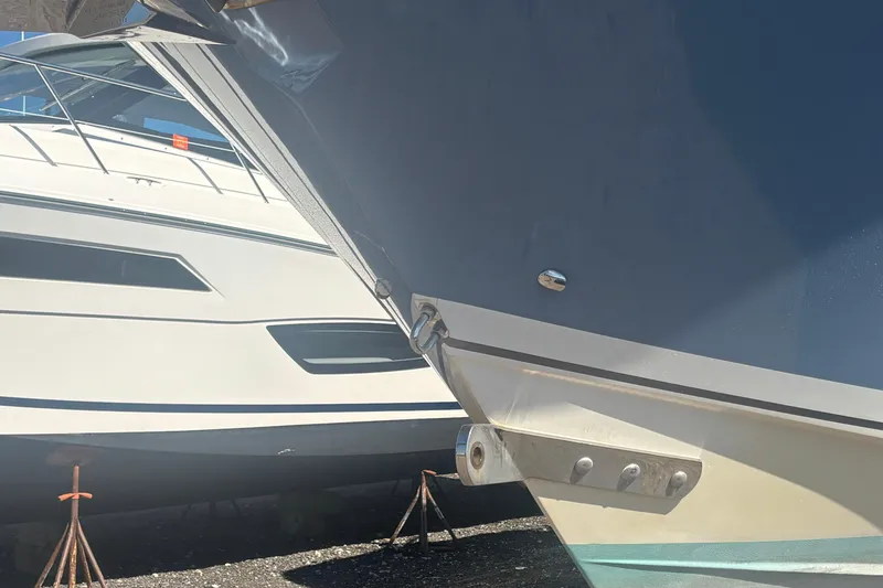 Slide: The Image of 2021 Pursuit S 378 Sport boat hulls in dry dock, side view. - 22