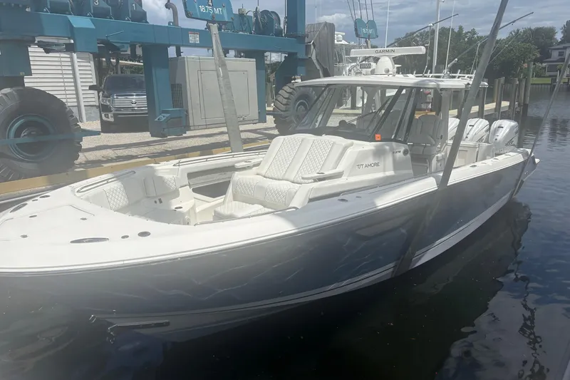 Slide: The Image of 2021 Pursuit S 378 Sport boat docked in marina, featuring sleek design and modern amenities. - 3