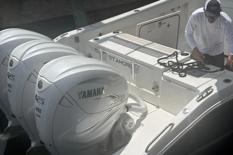 Slide: The Image of 2021 Pursuit S 378 Sport boat with Yamaha engines and person handling ropes. - 6