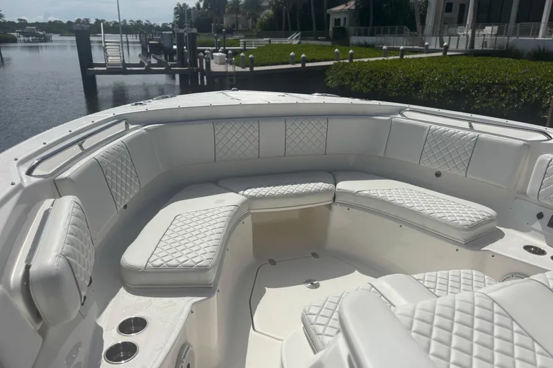 Slide: The Image of Luxurious seating on 2021 Pursuit S 378 Sport boat, docked by serene waterfront. - 7