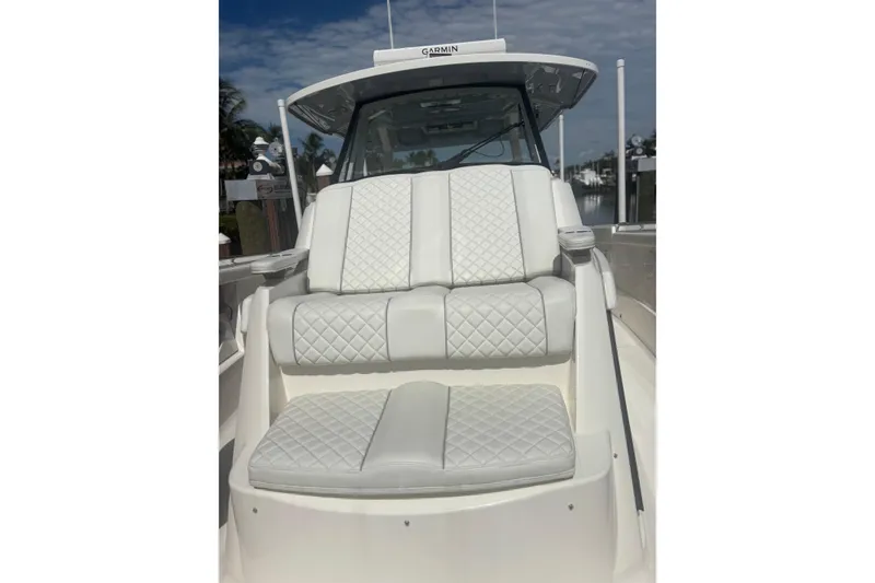 Slide: The Image of 2021 Pursuit S 378 Sport boat with luxurious white quilted seating. - 8