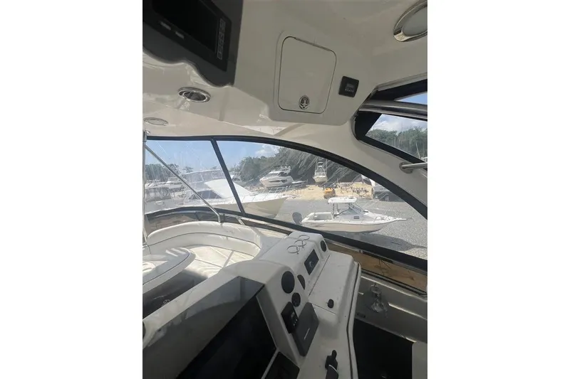 Slide: The Image of Interior view of 2007 Sea Ray 52 Sedan Bridge yacht cockpit with dashboard and windows. - 13