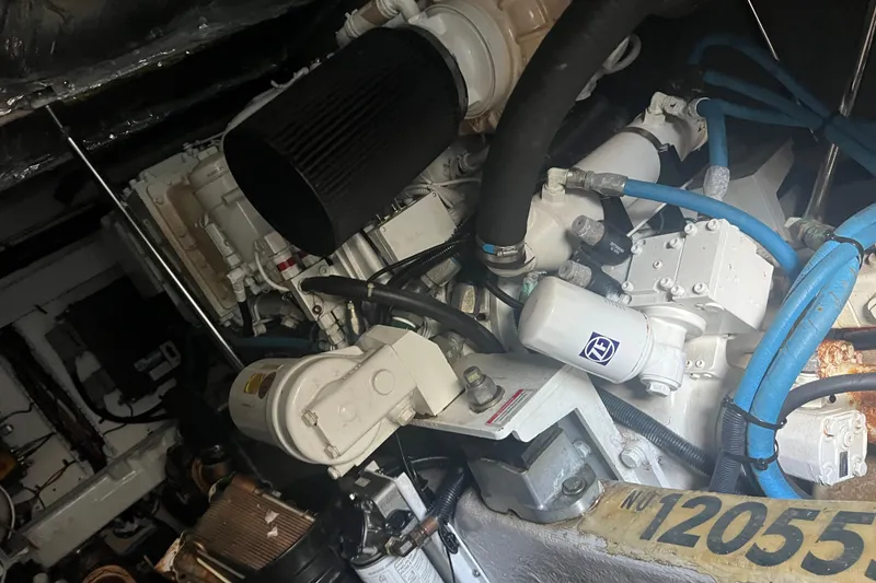 Slide: The Image of Engine room of 2007 Sea Ray 52 Sedan Bridge with visible components and hoses. - 14