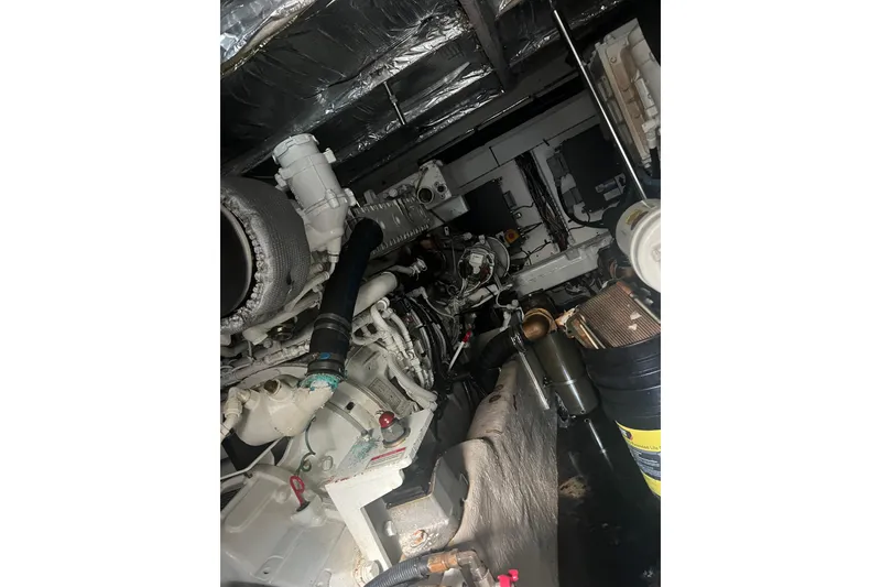 Slide: The Image of Engine room of 2007 Sea Ray 52 Sedan Bridge yacht, showcasing mechanical components. - 17