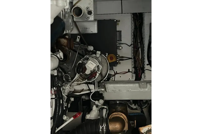 Slide: The Image of Engine compartment of a 2007 Sea Ray 52 Sedan Bridge yacht, showing mechanical components and wiring. - 18