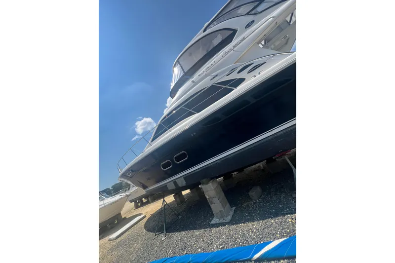 Slide: The Image of 2007 Sea Ray 52 Sedan Bridge yacht on dry dock under clear blue sky. - 21
