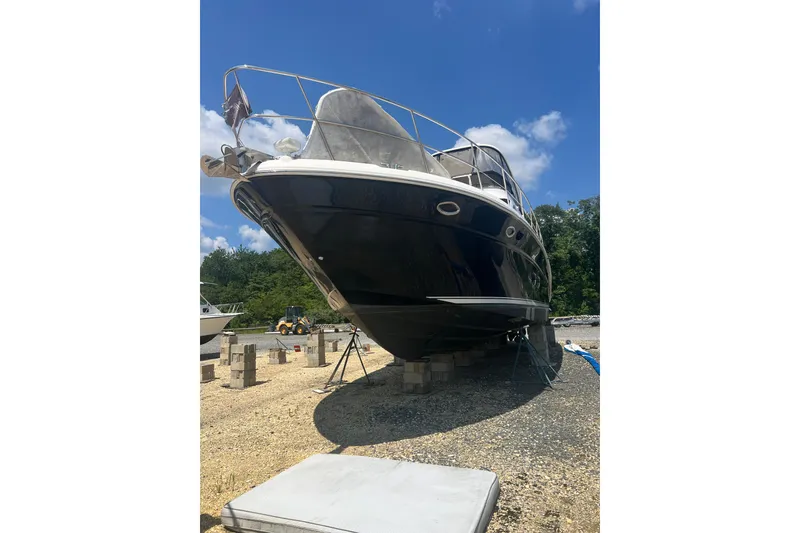 Slide: The Image of 2007 Sea Ray 52 Sedan Bridge yacht on dry dock under clear blue sky. - 23