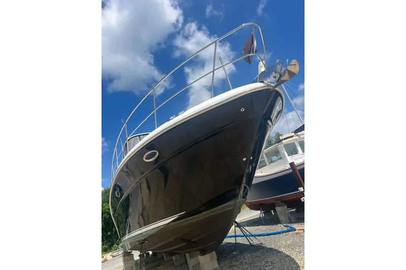 Slide: The Image of 2007 Sea Ray 52 Sedan Bridge yacht on dry dock under a clear blue sky. - 24