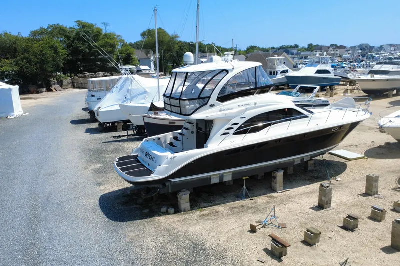 Slide: The Image of 2007 Sea Ray 52 Sedan Bridge yacht on dry dock in a marina setting. - 28