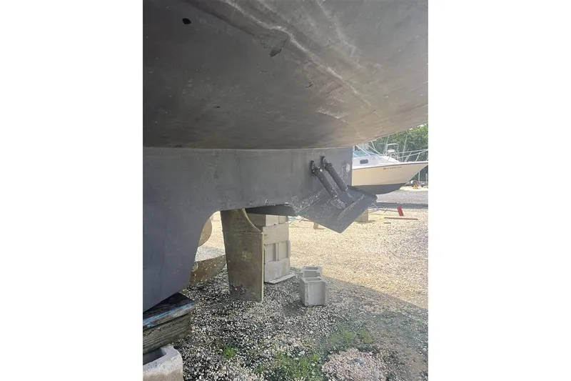 Slide: The Image of 2007 Sea Ray 52 Sedan Bridge hull and propeller detail in a boatyard. - 3