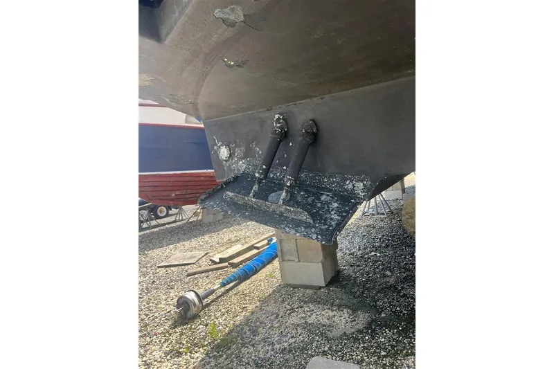 Slide: The Image of 2007 Sea Ray 52 Sedan Bridge hull on blocks, showing propeller shaft and rudder. - 6