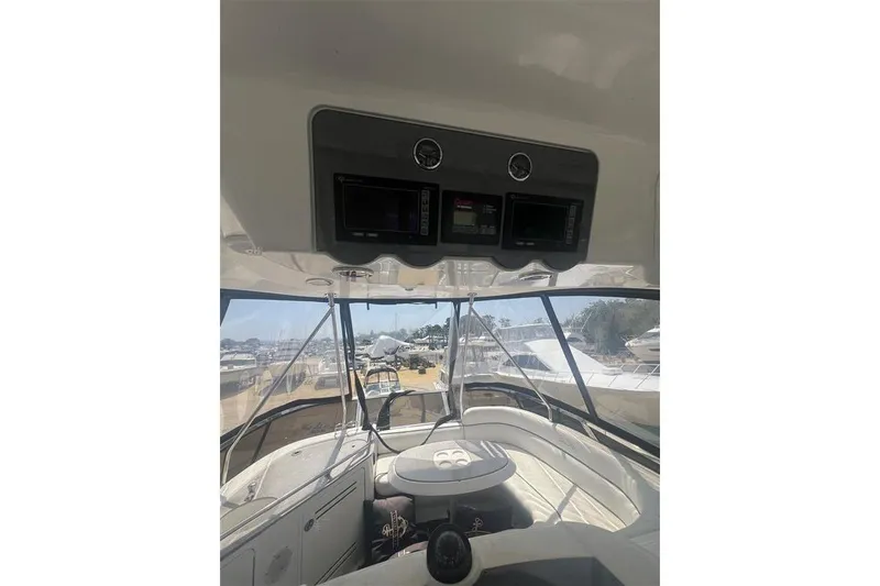 Slide: The Image of 2007 Sea Ray 52 Sedan Bridge interior with control panel and seating area. - 9