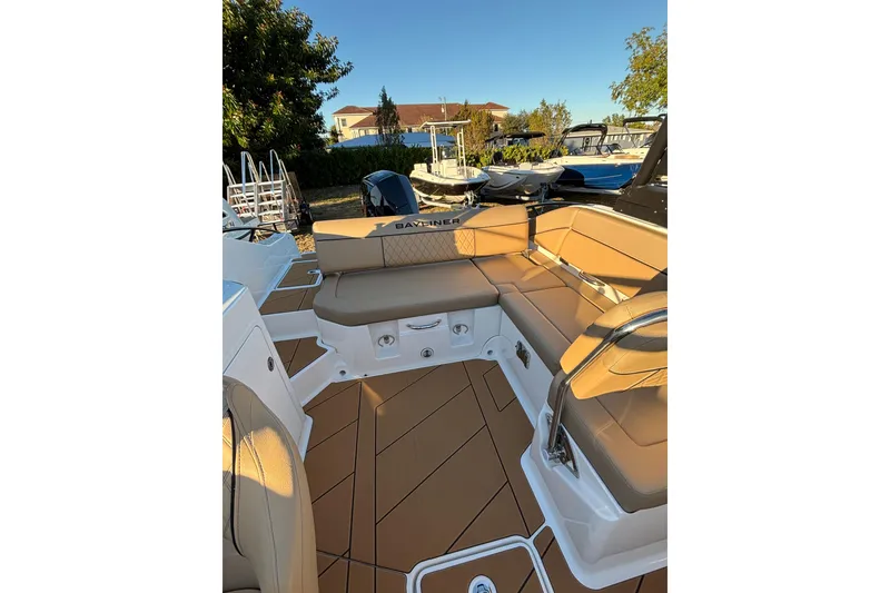 Slide: The Image of 2026 Bayliner D22 boat interior with tan seating and sleek design. - 15