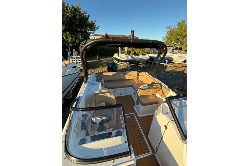 Slide: The Image of 2026 Bayliner D22 boat with sleek interior and modern design, docked outdoors. - 16