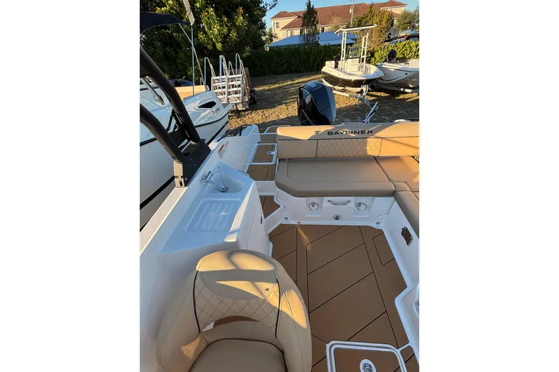 Slide: The Image of 2026 Bayliner D22 boat interior with tan seating and modern design. - 19
