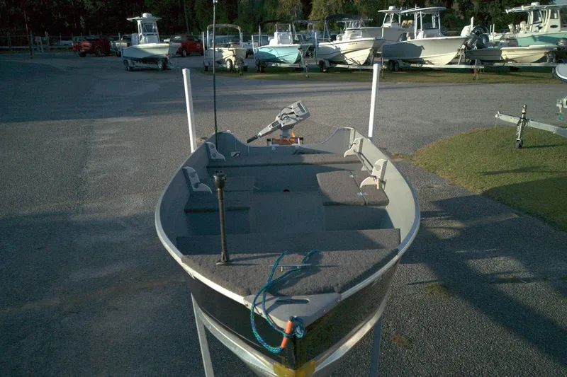 Slide: The Image of 2021 Smoker Craft 14 Big Fish boat in a parking lot with other boats. - 4
