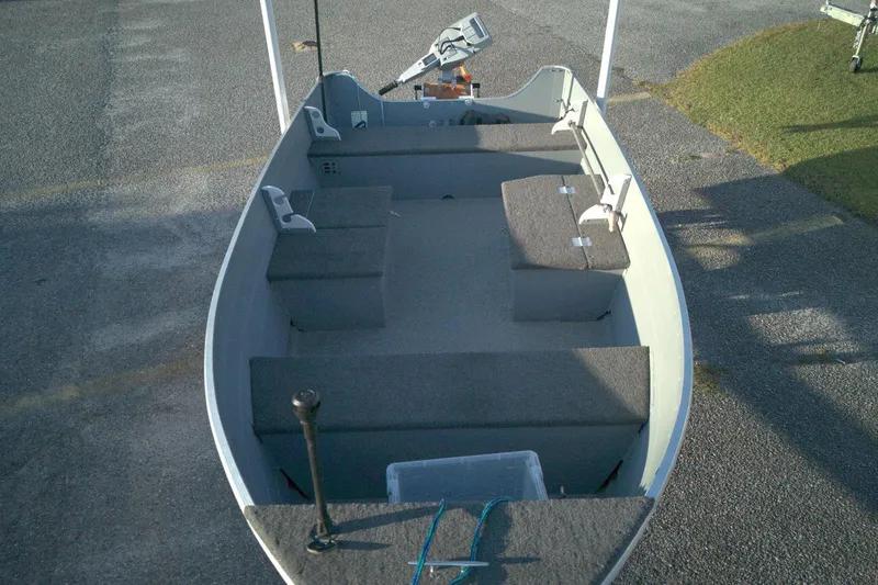 Slide: The Image of 2021 Smoker Craft 14 Big Fish boat interior with seating and motor. - 6