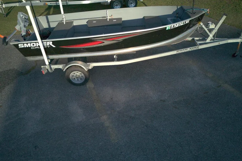 Slide: The Image of 2021 Smoker Craft 14 Big Fish boat on trailer, parked on asphalt. - 9
