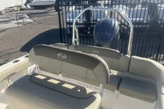 Slide: The Image of 2023 Key West 203 FS boat interior with seating and engine view. - 11