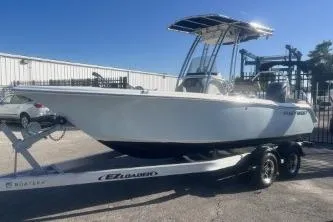 Slide: The Image of 2023 Key West 203 FS boat on trailer in sunny outdoor setting. - 4