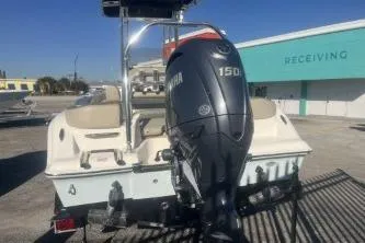 Slide: The Image of 2023 Key West 203 FS boat with Yamaha 150 engine, parked near a receiving area. - 6