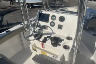 Slide: The Image of 2023 Key West 203 FS boat console with steering wheel and controls. - 8