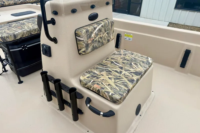 Slide: The Image of 2026 Carolina Skiff E21 DLX CC boat seat with camouflage cushions and rod holders. - 15