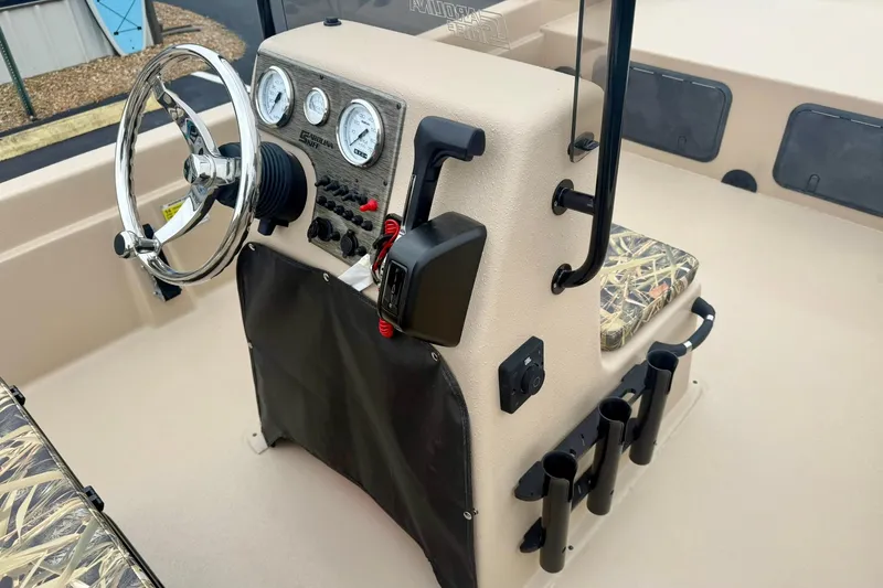 Slide: The Image of 2026 Carolina Skiff E21 DLX CC boat console with steering wheel and gauges. - 17