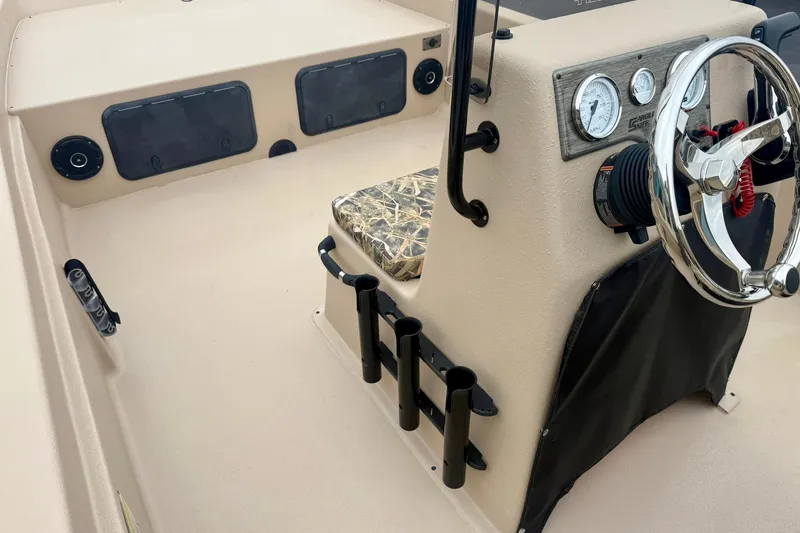 Slide: The Image of 2026 Carolina Skiff E21 DLX CC boat interior with steering wheel and control panel. - 18