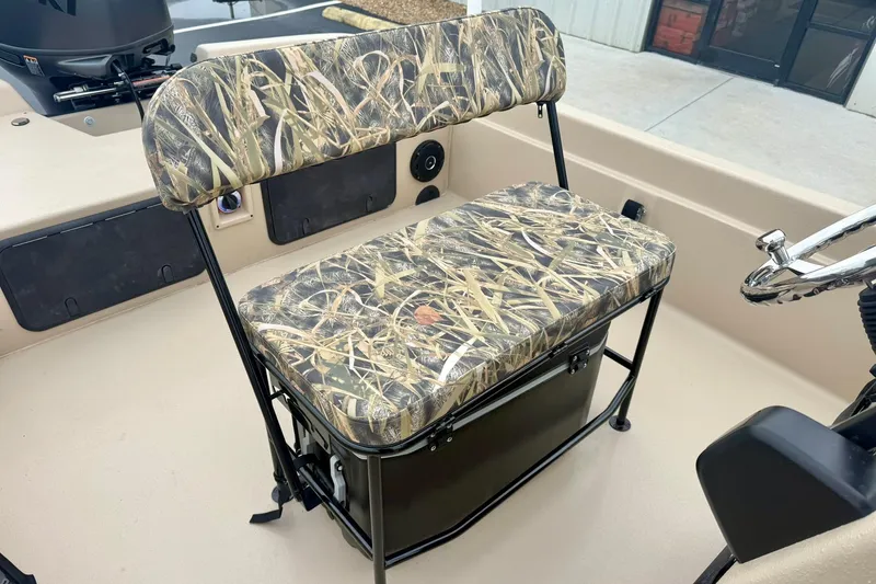 Slide: The Image of 2026 Carolina Skiff E21 DLX CC boat seat with camouflage pattern and steering wheel. - 19