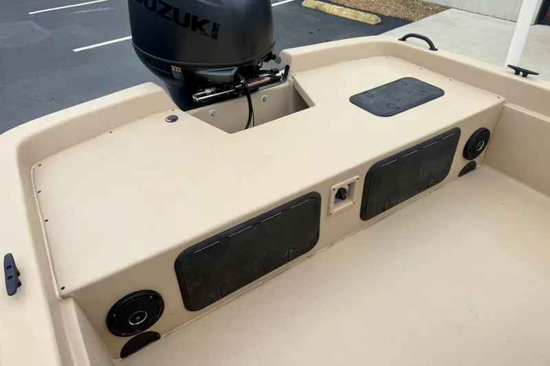 Slide: The Image of 2026 Carolina Skiff E21 DLX CC boat with Suzuki outboard motor, rear deck view. - 23