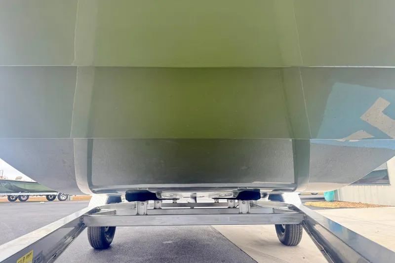 Slide: The Image of 2026 Carolina Skiff E21 DLX CC boat hull on trailer, showcasing underside design. - 9