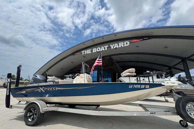 Slide: The Image of 2015 Xpress H20 boat on trailer at The Boat Yard, under cloudy sky. - 1