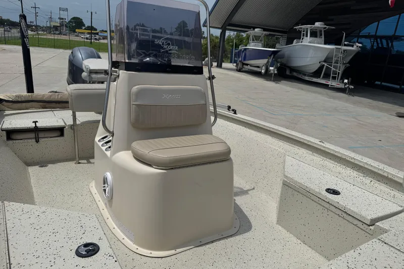 Slide: The Image of 2015 Xpress H20 boat interior with seating and console, displayed outdoors. - 10