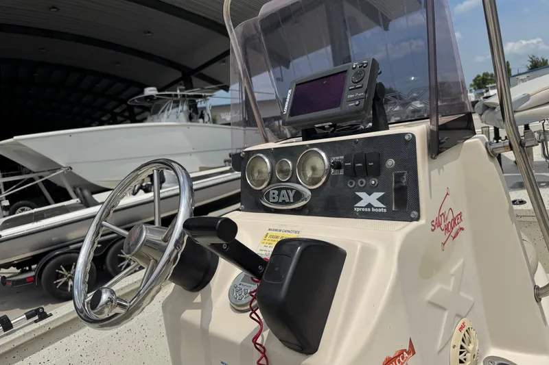 Slide: The Image of 2015 Xpress H20 boat console with steering wheel and navigation system. - 14