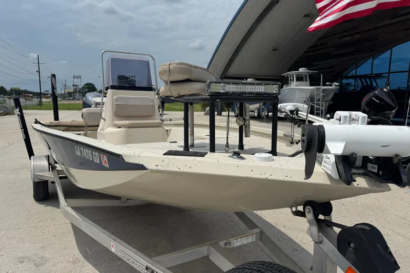 Slide: The Image of 2015 Xpress H20 boat on trailer, outdoor display, American flag in background. - 6