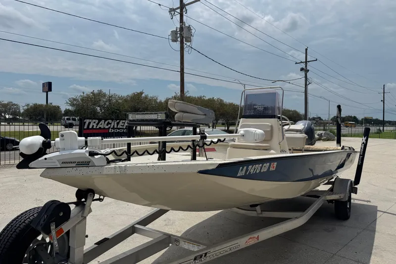 Slide: The Image of 2015 Xpress H20 boat on trailer, parked outdoors under cloudy sky. - 9