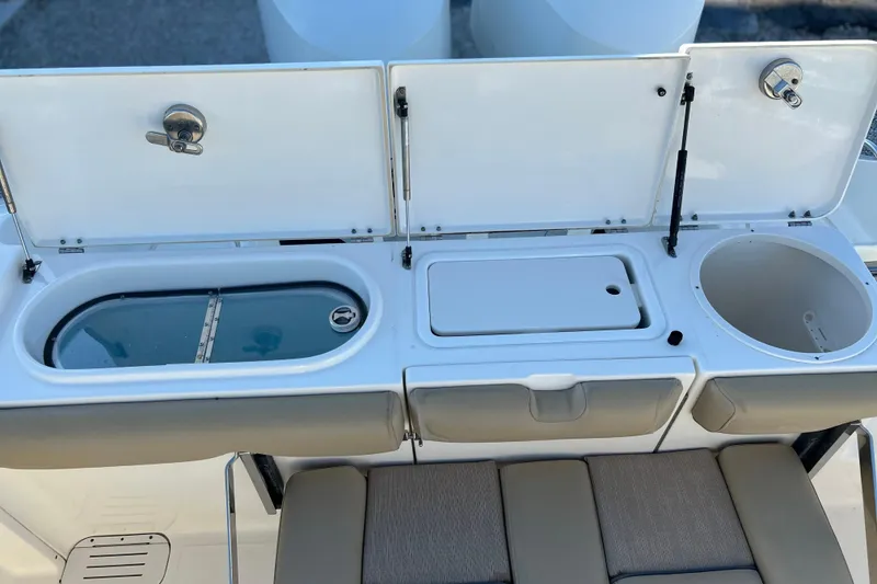 Slide: The Image of 2017 Key West Billistic 281 Center Console boat with open storage compartments. - 12