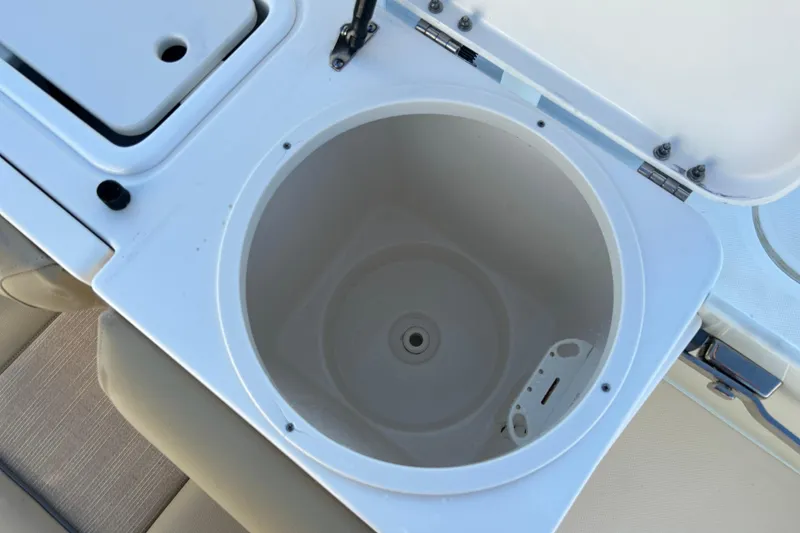 Slide: The Image of 2017 Key West Billistic 281 Center Console livewell, open lid, white interior. - 13