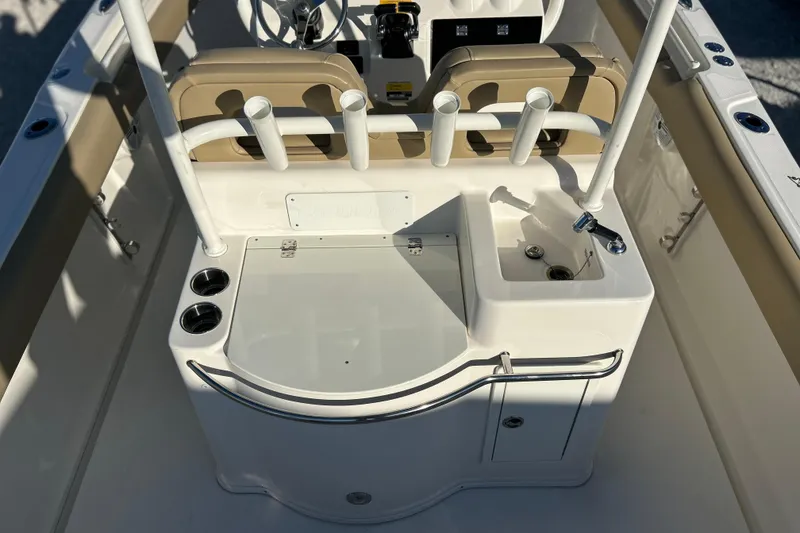 Slide: The Image of 2017 Key West Billistic 281 Center Console boat interior with rod holders and sink. - 16