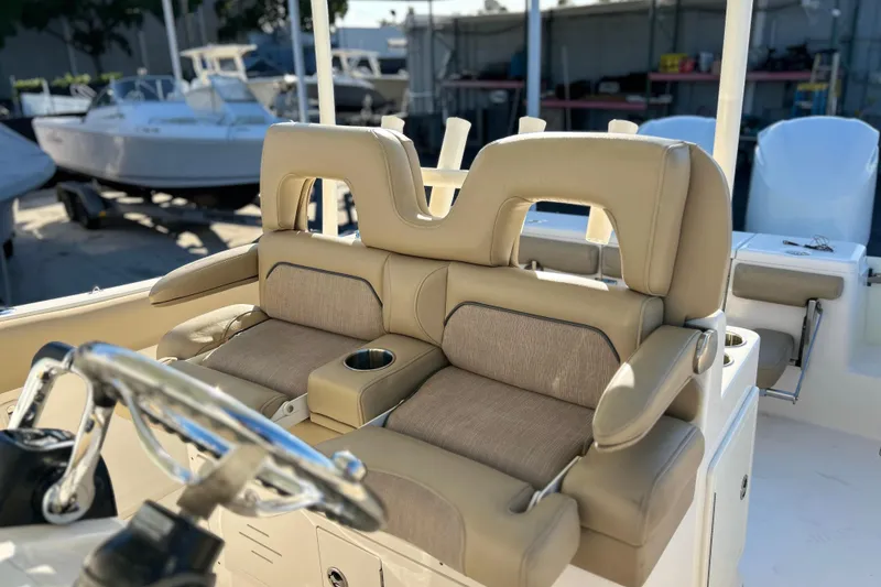 Slide: The Image of 2017 Key West Billistic 281 Center Console boat with beige seating and steering wheel. - 26