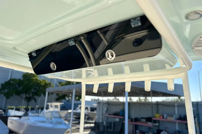 Slide: The Image of 2017 Key West Billistic 281 Center Console boat detail with rod holders and storage compartment. - 27