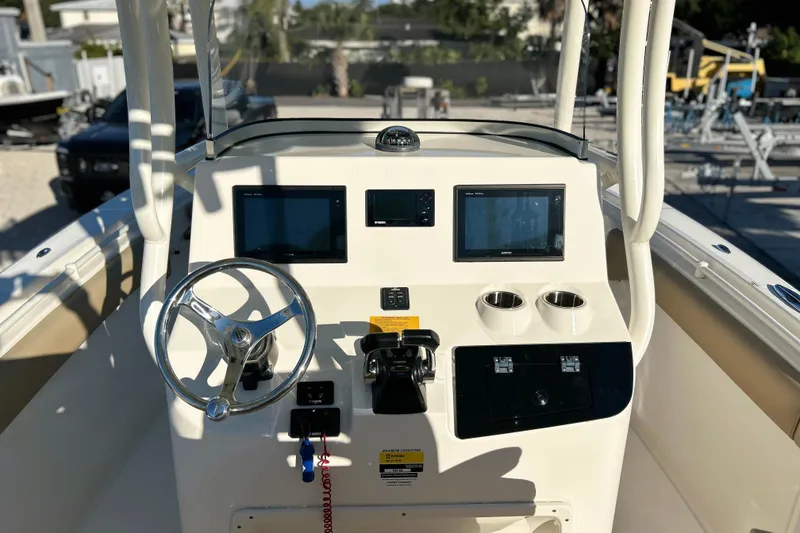 Slide: The Image of 2017 Key West Billistic 281 Center Console boat dashboard with steering wheel and controls. - 28