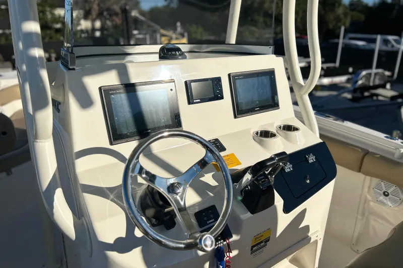 Slide: The Image of 2017 Key West Billistic 281 Center Console dashboard with steering wheel and navigation screens. - 29