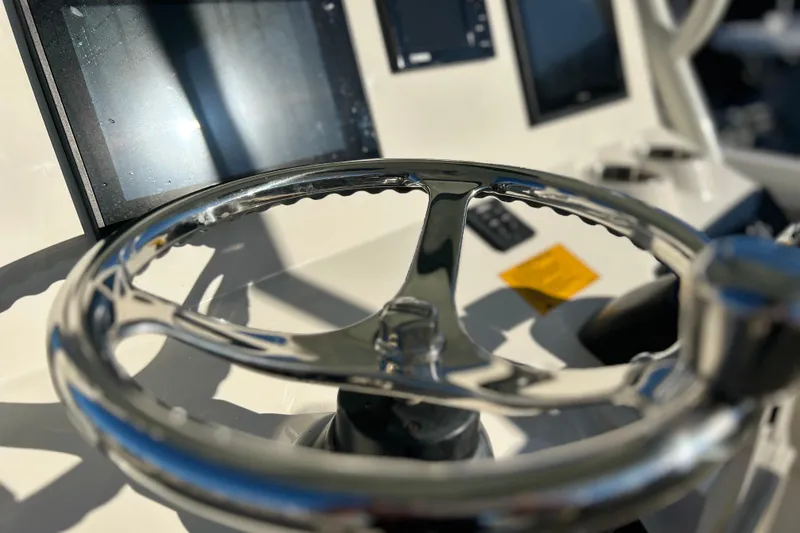 Slide: The Image of Steering wheel of 2017 Key West Billistic 281 Center Console boat, with control panel. - 30