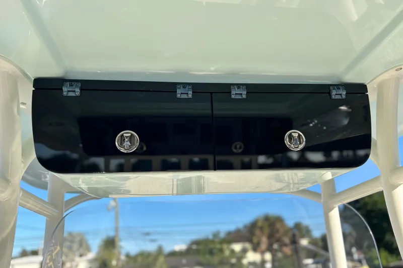 Slide: The Image of 2017 Key West Billistic 281 Center Console storage compartment with sleek black finish. - 31