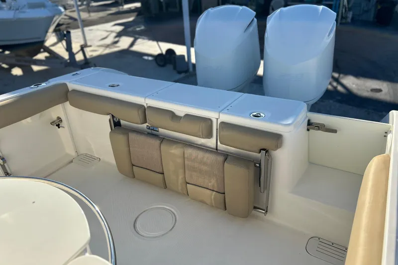 Slide: The Image of 2017 Key West Billistic 281 Center Console boat interior with seating and dual engines. - 7